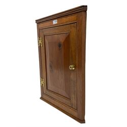 Mahogany wall hanging corner cupboard of small proportions, enclosed by unusual figured and fielded panel door
