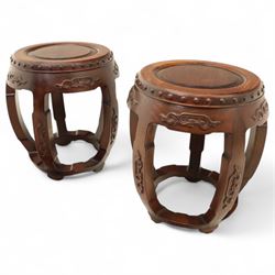 Pair of early 20th century Oriental hardwood barrel seats, of drum form with shaped apron and pierced panels, carved with stylised scrollwork and studded detail to the top