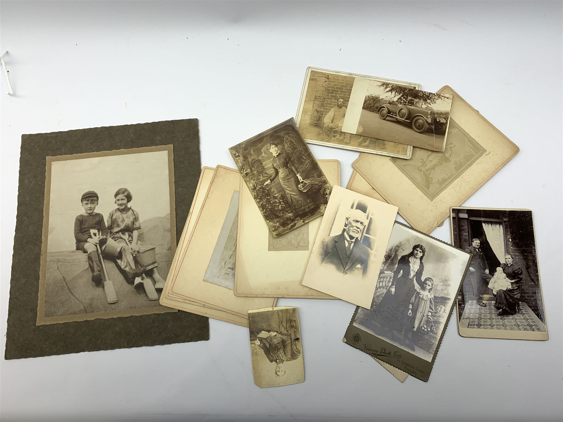 Early 20th century Japanese postcard album, the lacquered wooden covers with shibayama panel to the front, partially stocked with fifty Japanese postcards; Victorian album containing fifty-six laid-in photographs of British & Continental topographical scenes; mid-20th century album of Norwegian photographs; and quantity of Victorian cabinet photographs etc