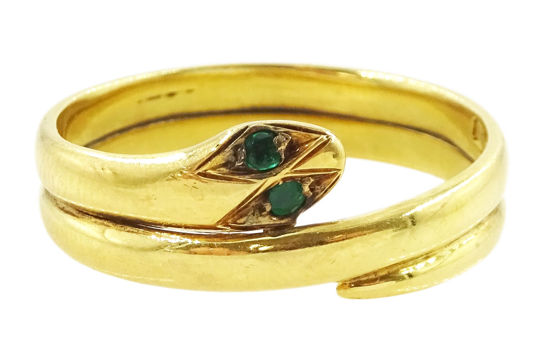 Early 20th century 18ct gold coiled snake ring, with green stone set eyes
