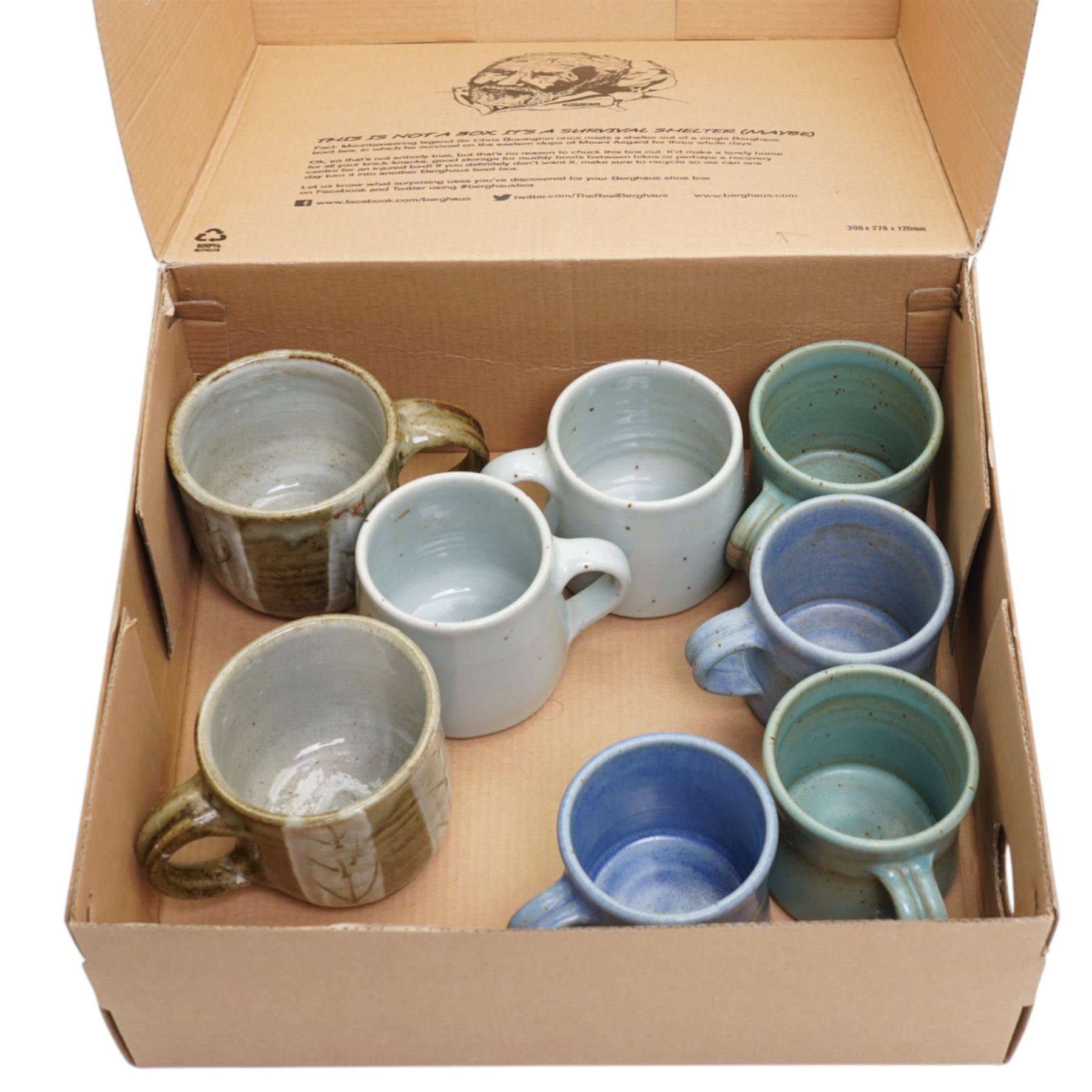 Tony Gant (British 20th Century) - set of six studio pottery stoneware mugs, in various blue glazes, with impressed marks to bases, together with two other studio pottery mugs, unmarked (8)