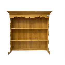 Pine media or television cabinet, enclosed by single glazed door (W56cm, H82cm, D43cm); pine corner cupboard, three shelves over single cupboard (W76cm, H188cm); pine two-tier plate rack with shaped frieze and uprights (W113cm, H107cm)