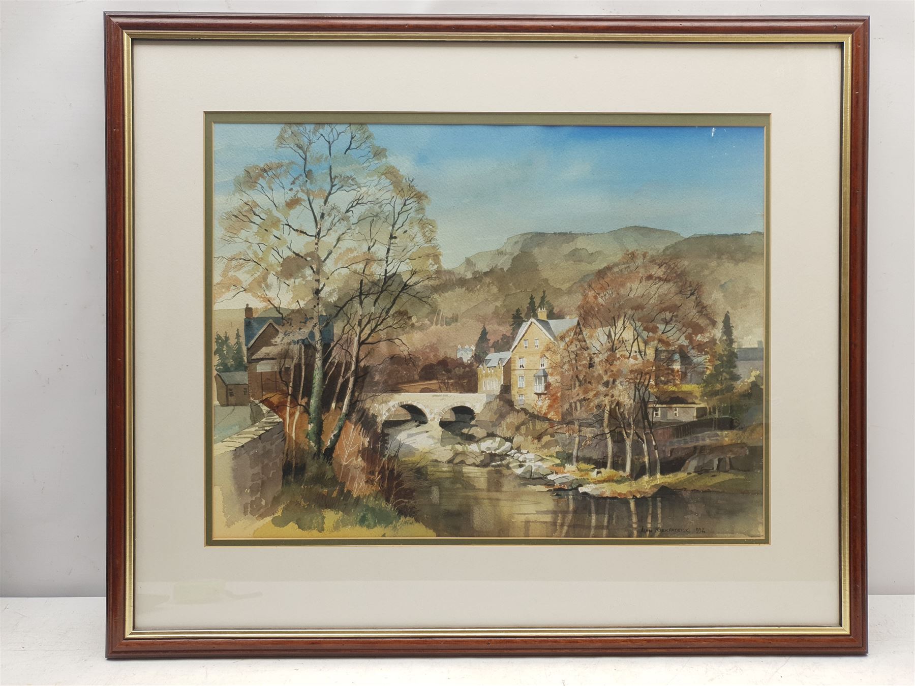 Alan Kirkpatrick (British 1929-): Welsh Village with River, watercolour signed and dated 1992, 39cm x 52cm