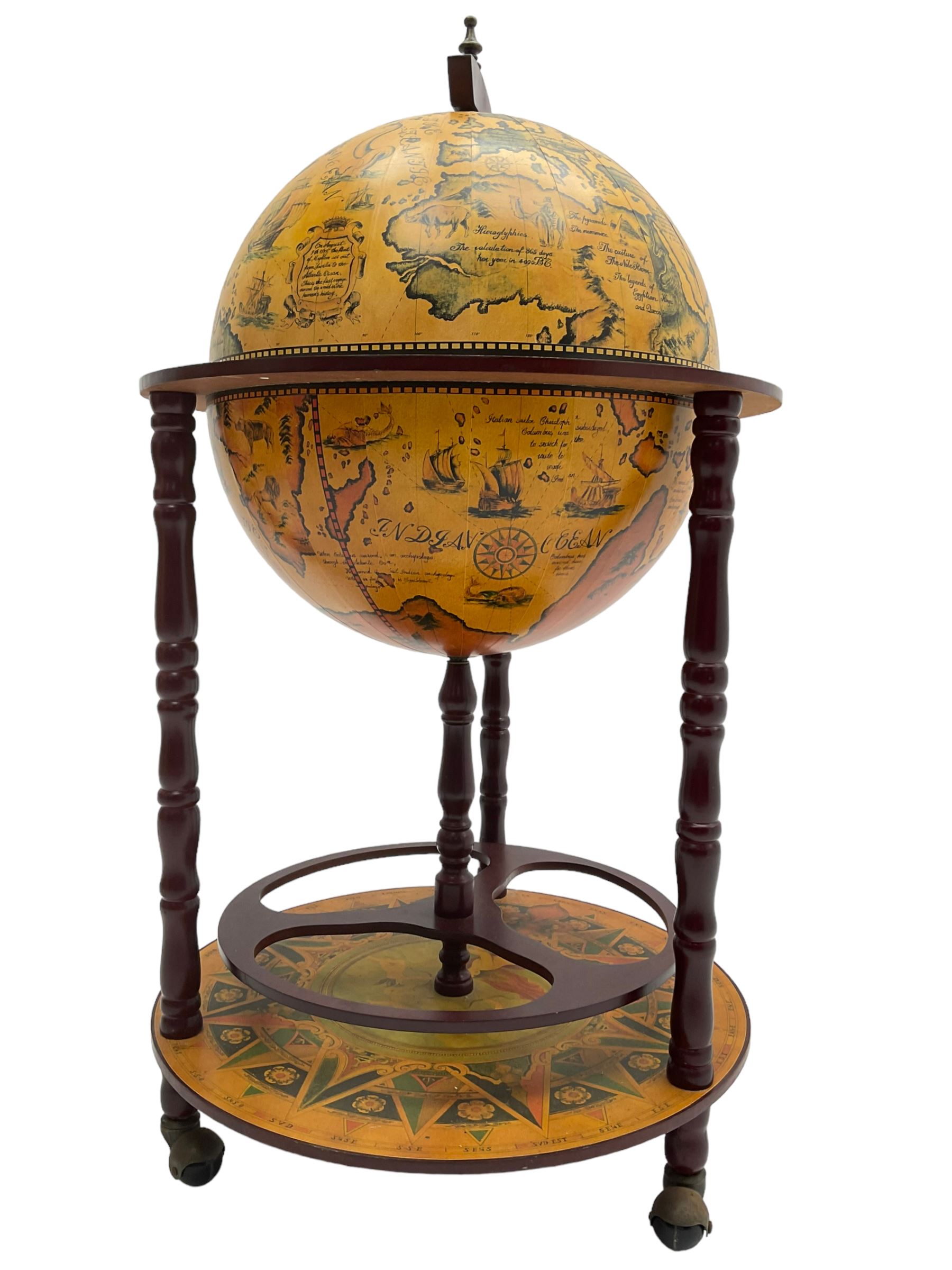 Drinks globe cocktail cabinet trolley, the globe hinges open to reveal drinks holders, turned supports on lower platform, on castors