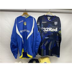 Fourteen items of replica sporting clothing including Leeds United football club shirts, England jerseys etc
