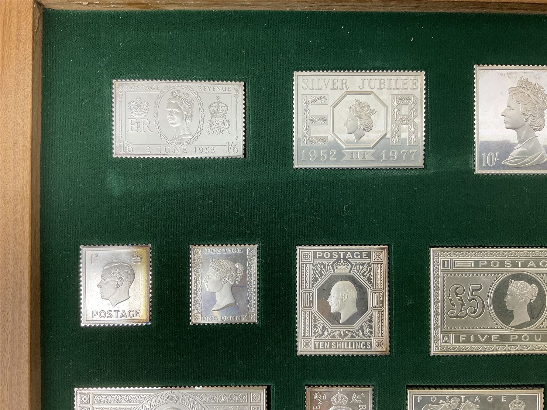 The Stamps of Royalty collection consisting of twenty-five sterling silver hallmarked stamp replicas, housed in a fitted wooden display case, with certificates, polishing cloth and certificates