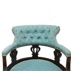 Late Victorian mahogany upholstered tub chair, curved button-back with rope-edge trim over open shaped arms and pierced splat supports, rounded seat upholstered in patterned blue fabric, raised on cabriole front supports