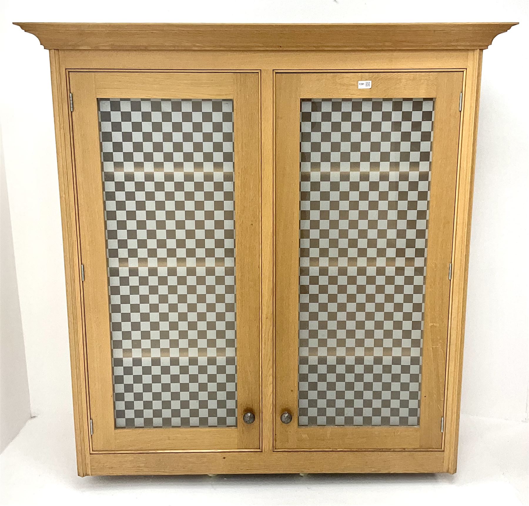 Smallbone light oak bookcase, projecting cornice above two chequered opaque glazed doors enclosing three adjustable shelves