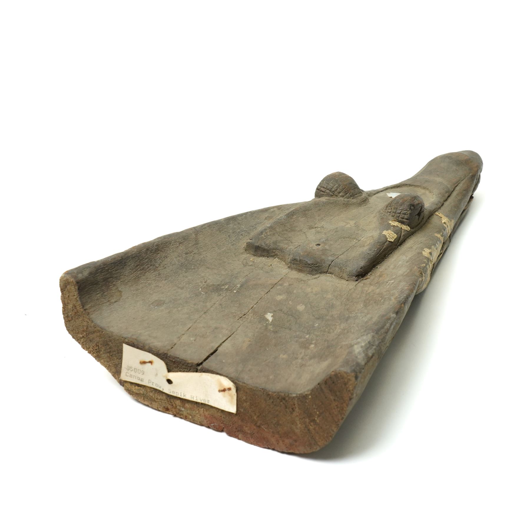 East-Java winged oil lamp, dlupak/ celupak, H64cm and a canoe prow from Sepik river, Papua New Guinea carved as the head of a crocodile L42cm