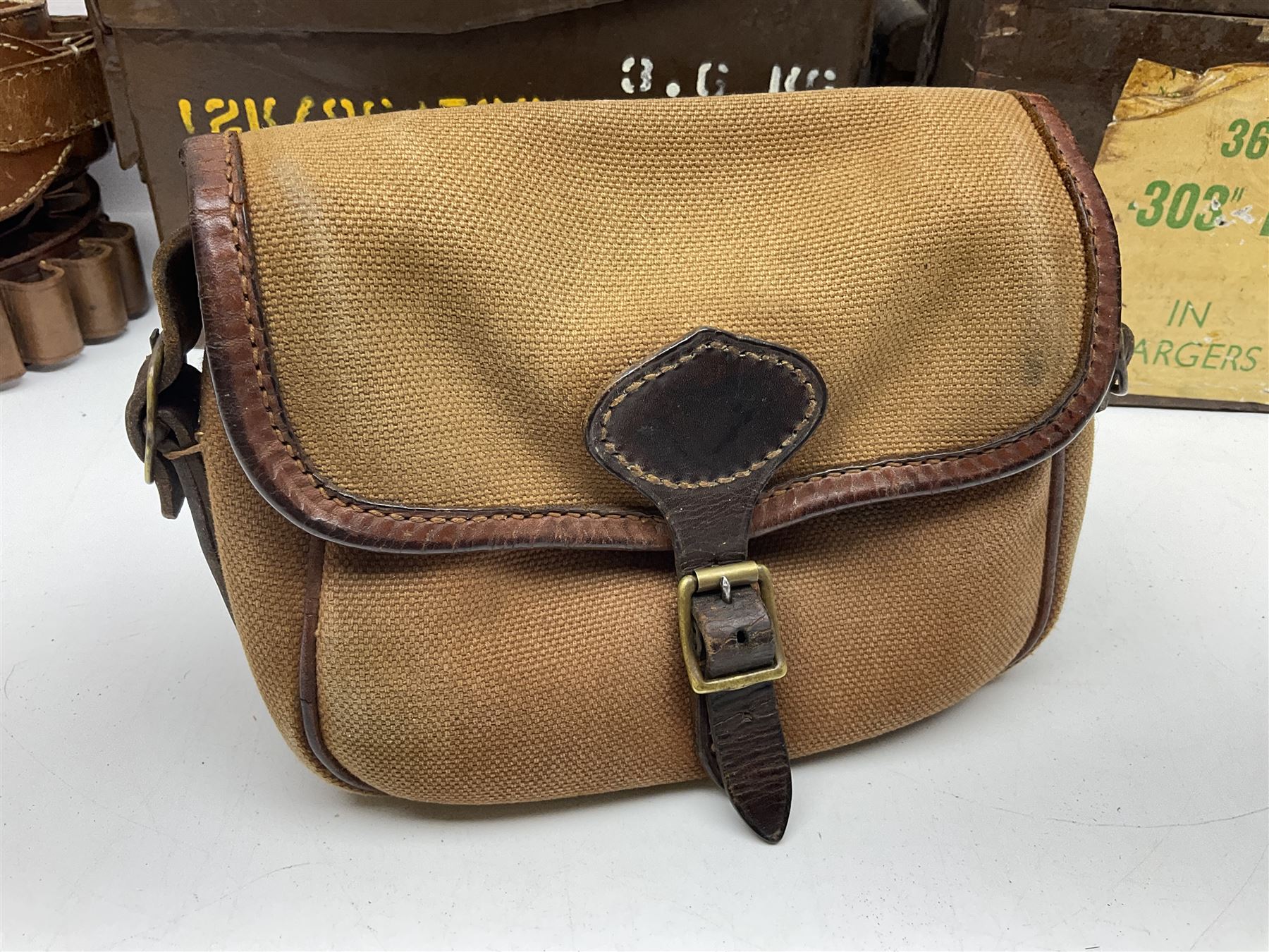 Miscellaneous shooting accessories - W.J. Bowman & Sons clay pigeon launcher; two leather cartridge belts; three cartridge bags; two canvas/leather game bags; and two metal/wooden cartridge boxes