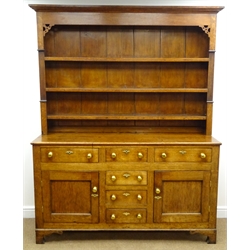  19th century oak dresser, projecting conrice, three shelf plate rack, two short and four long drawers, two cupboard doors, shaped bracket supports, W170cm, H209cm, D50cm  