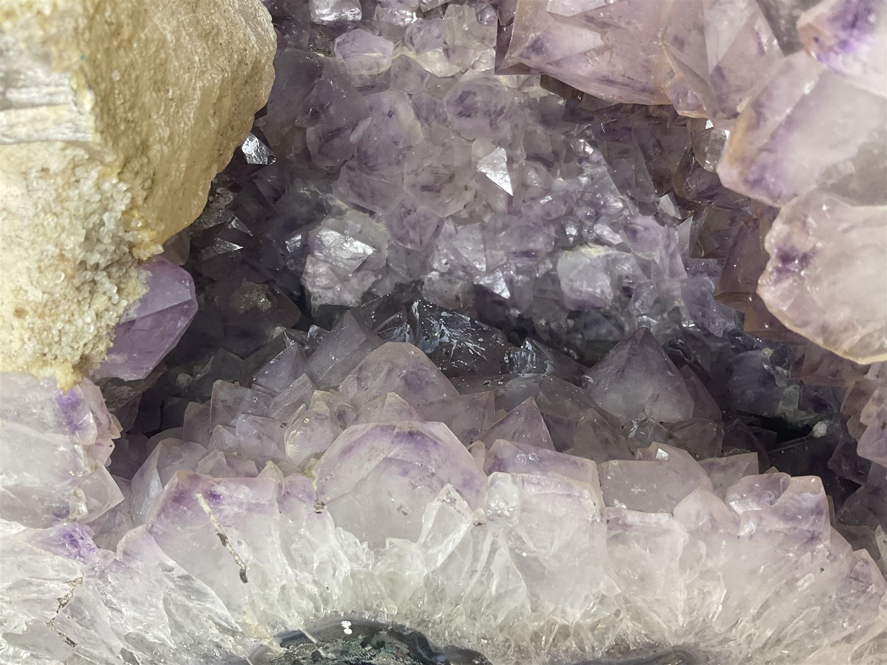 Amethyst crystal ‘cathedral’ geode, free standing with flat base and prepared outer surface, with well-defined crystals of various sizes within the cavern, H39, L32cm