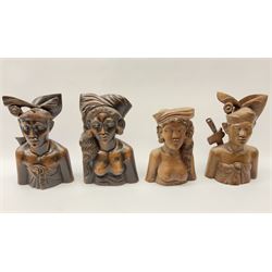 Two pairs of Balinese carved wooden bust figures of a man and woman, with elaborate head dresses, along with other wooden carved figures, a small barometer and a framed print. 