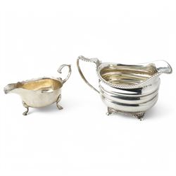 George III silver cream jug with gadrooned edge and leaf capped handle on shaped supports London 1817 Maker Robert Peppin and a small Victorian silver sauce boat with crimped rim Birmingham 1893 Maker Thomas Hayes (2)