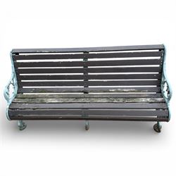 Victorian cast iron garden bench with dark wooden slats and ornate green painted ends.