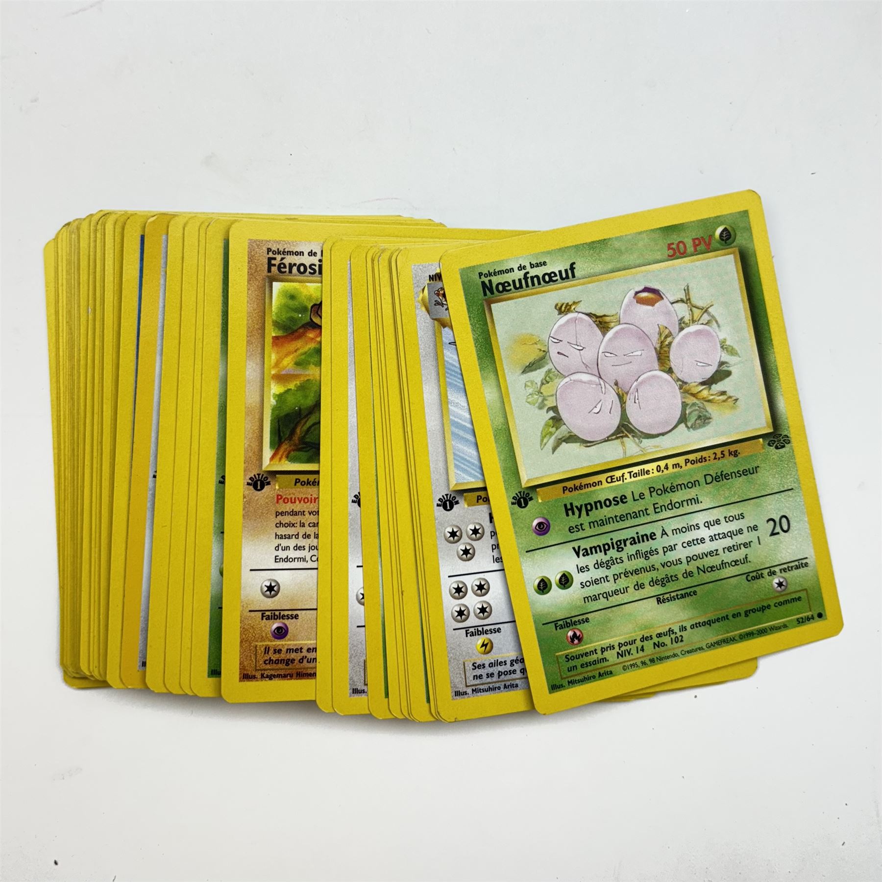 Collection of vintage English and French language Pokemon TCG trading cards, approximately eighty English cards housed in Pokemon file, including Base Set, Base Set 2, Team Rocket, Neo Discovery, Jungle and Fossil examples, with thirteen holos including Charizard 4/102, Dark Blastoise 3/82, Ninetales 12/102, Mewtwo 10/102, and First Edition Machamp 81/102, approximately two hundred French language cards, many first editions, including four first edition holos, Roucarnage 8/64, Nidoqueen 7/64, Melodelfe 1/64 and Mackogneur 8/102, all loose, together with a Funfax Pokemon Collectors File