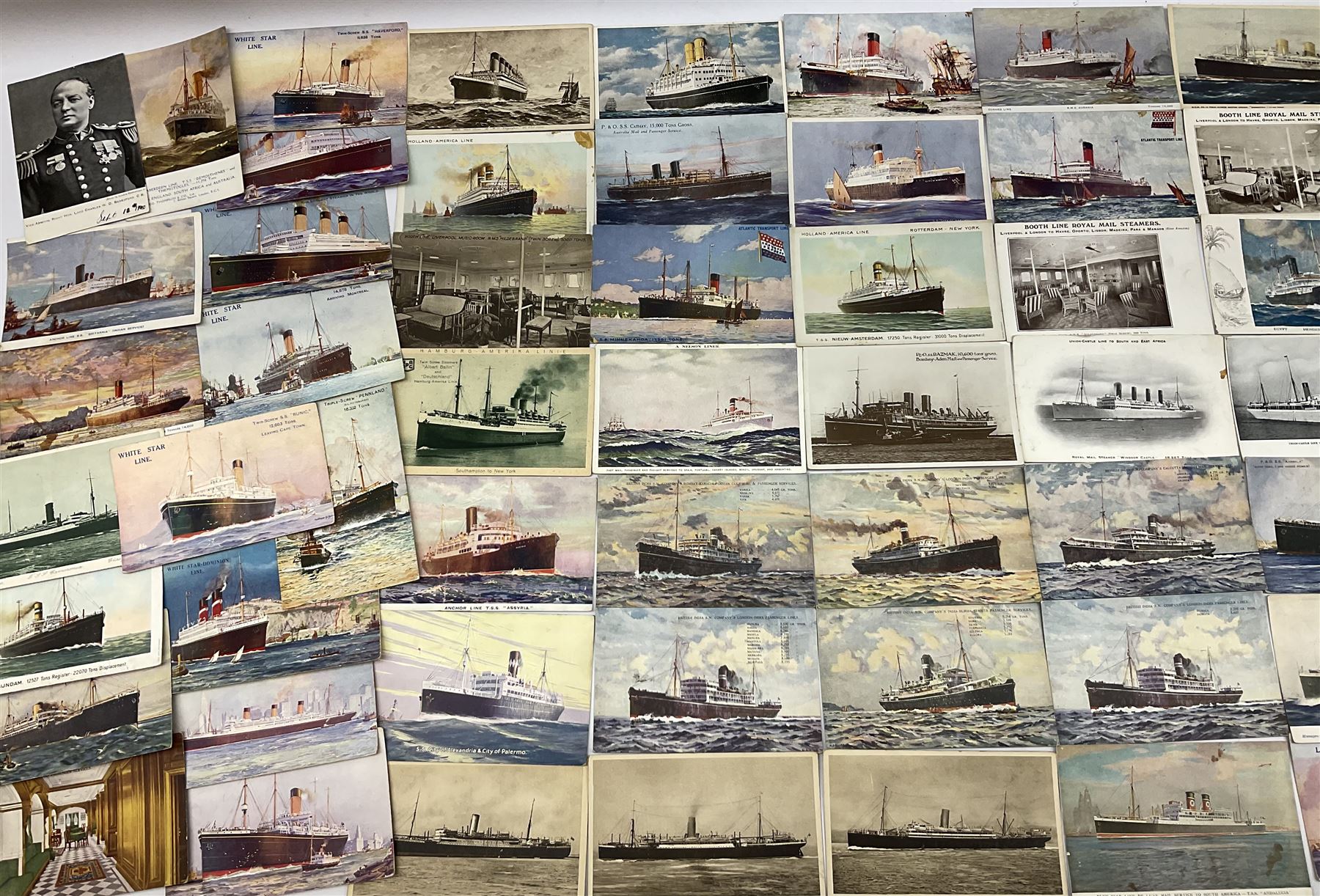 Sixty-five early 20th century postcards of passenger liners including White Star, Red Star, Atlantic Transport, Anchor, Cunard, Henderson, Booth, Union Castle, Holland America, Lamport & Holt, P. & O., New Zealand, Canadian Pacific, British India etc; and ten Edwardian postcards of Naval warships and officers (75)