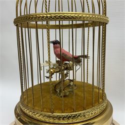 Swiss Reuge Music bird cage automaton music box, the bird with articulated head and beak, in a gilt brass cage, with a glass dome and stand, H30cm