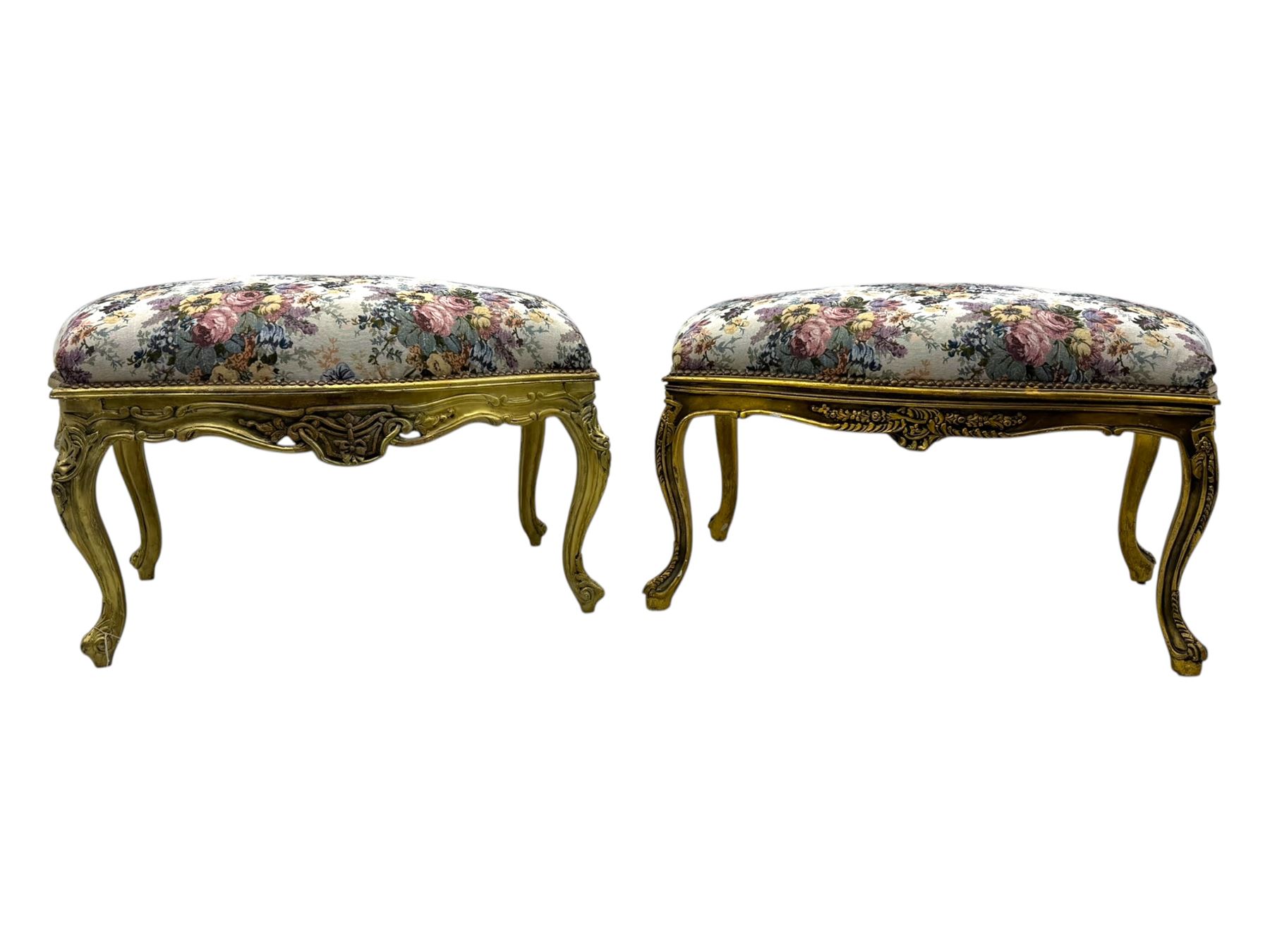 Pair of Louis XV-design giltwood stools, each upholstered in floral tapestry fabric, the carved frame adorned with scrolling foliage and shell motifs, raised on cabriole supports