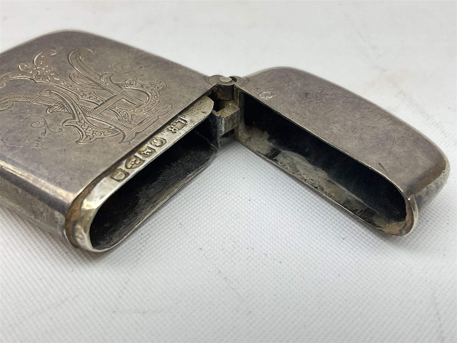 Victorian novelty brass vesta case modelled in the form of a pig holding a money bag, together with a silver vesta, hallmarked 