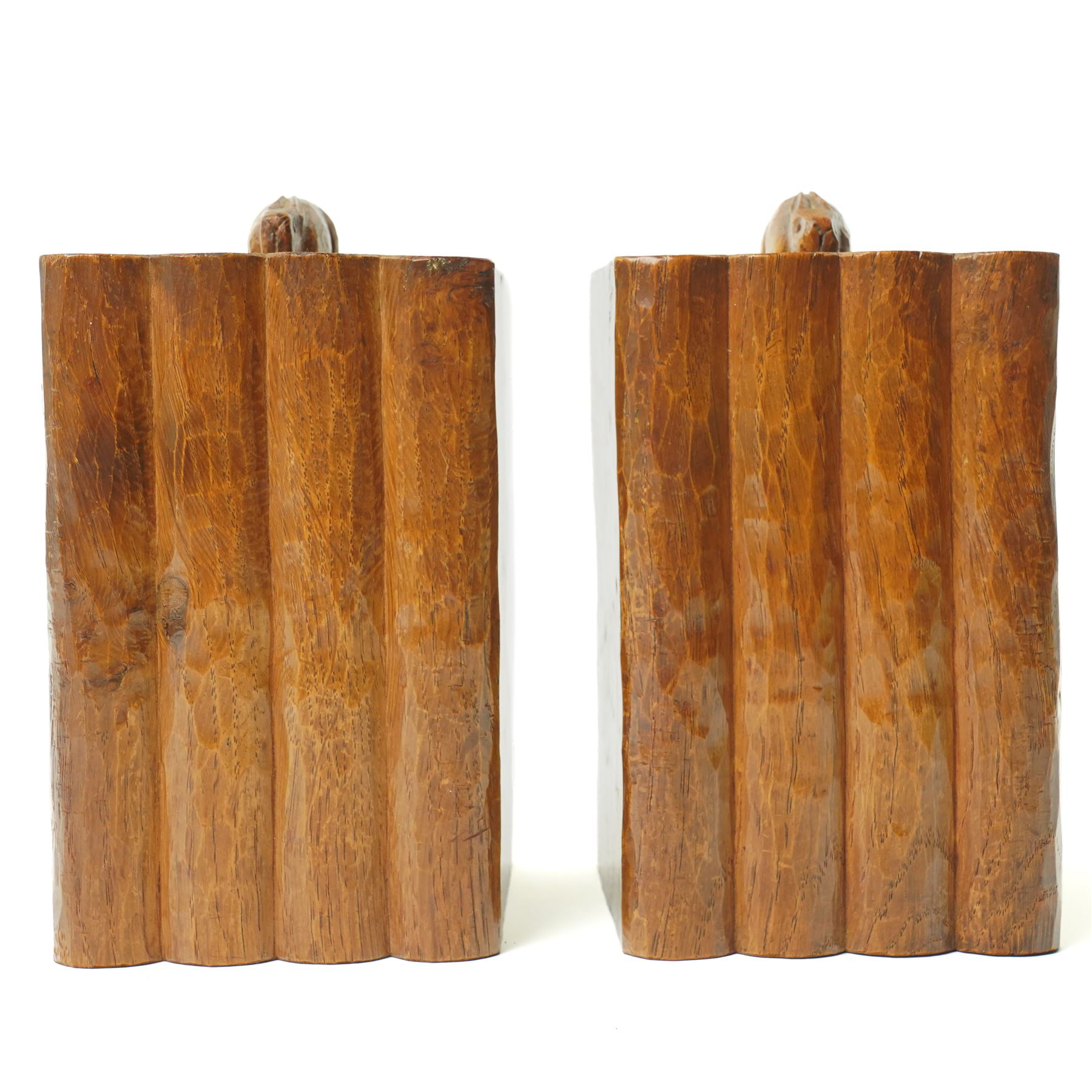 Rabbitman - pair of adzed oak bookends, each carved as a set of four books, with carved rabbit signature, by Peter Heap of Wetwang