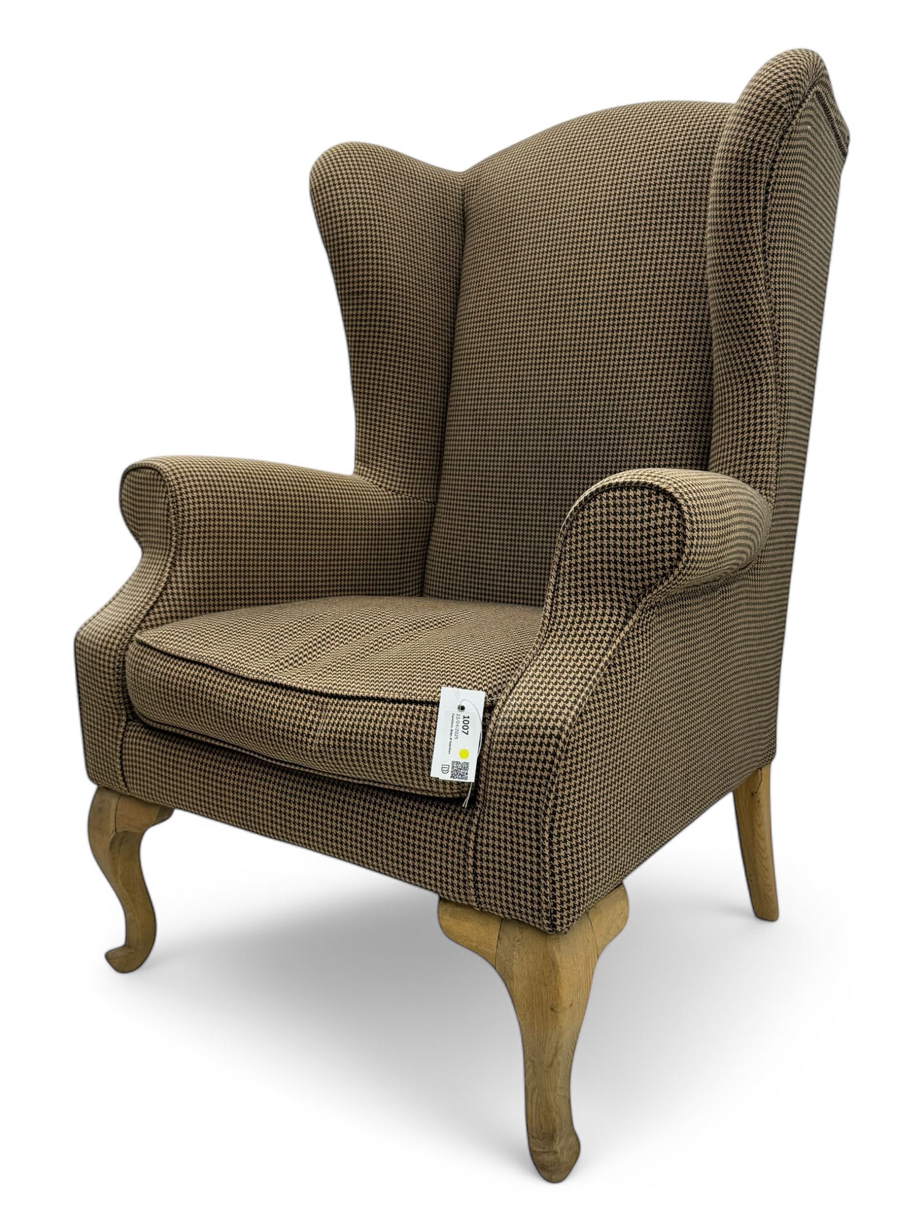 Hardwood-framed wingback armchair, upholstered in dog tooth pattern fabric, on cabriole supports 