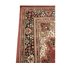 Persian design peach ground carpet, the field with flroal central medallion and spandrels, repeating border with flower heads and trailing branch