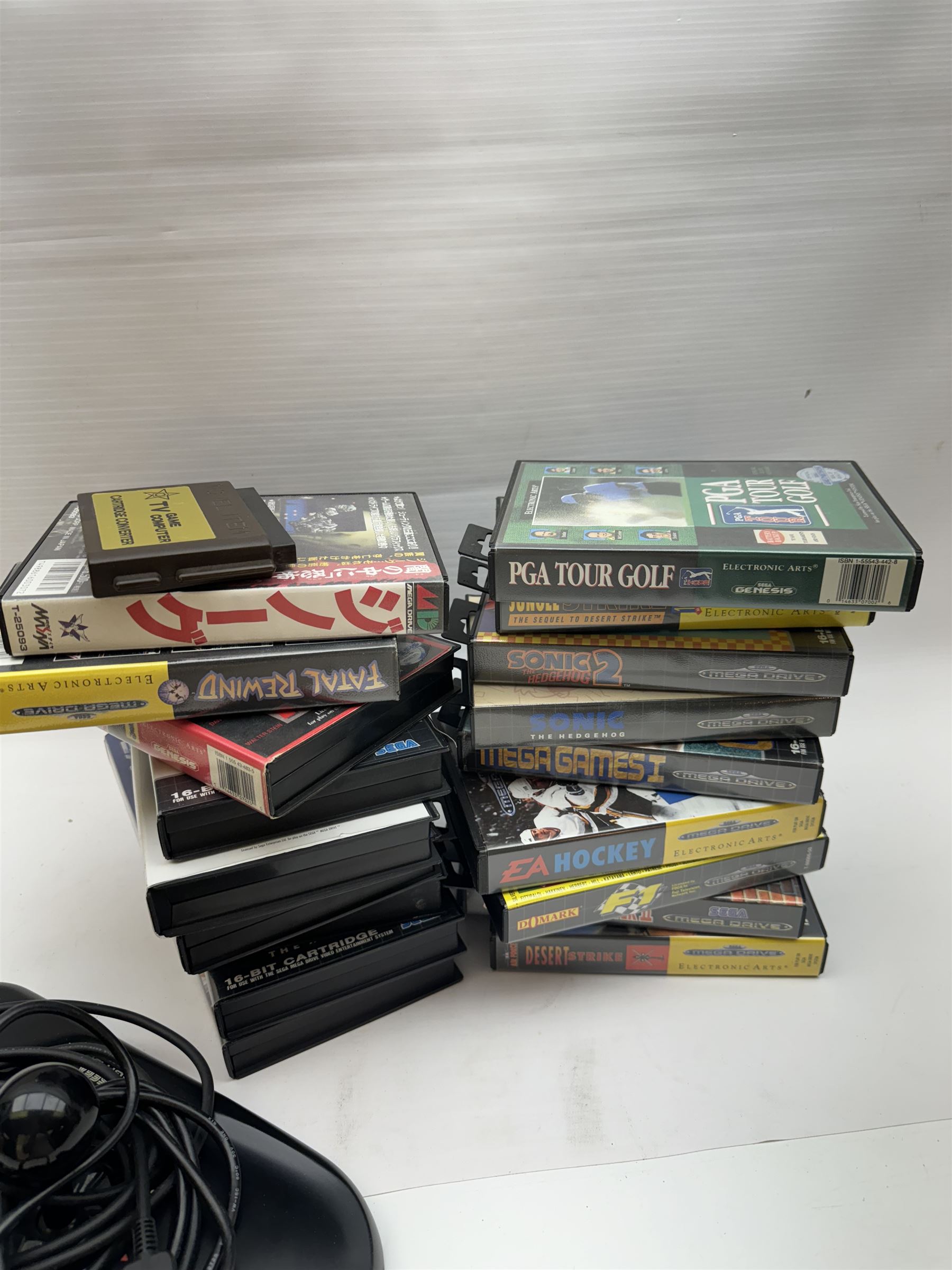 Eighteen Sega Mega Drive games, including Sonic The Hedgehog, Sonic The Hedgehog 2, Alienstorm, Desert Strike, Fatal Rewind, Road Rash etc, all boxed, together with a Sega Mega Drive controller, cartridge converter and an arcade power stick controller