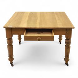 Contemporary pine kitchen table, rectangular top with moulded edge, fitted with single drawer, raised on turned supports with ceramic castors
