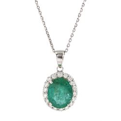18ct white gold oval emerald and round brilliant cut diamond cluster pendant, on silver chain, emerald approx 3.55 carat