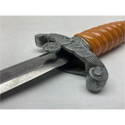 Late WW2 German Army Officers dress dagger, with unmarked 25cm double edged steel blade, orange celluloid grip, pommel and ferrule with oakleaves relief and cross guard with eagle; in original beaded scabbard with two hanging rings L39.5cm overall