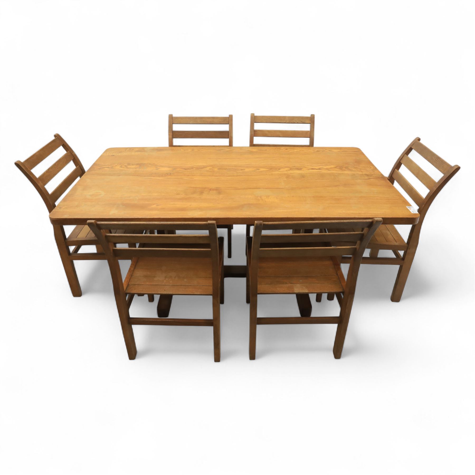 Treske of Thirsk - solid oak refectory dining suite, rectangular top with chamfered edge over trestle base united by a central stretcher, together with six matching slat back dining chairs, including two carvers, with panelled seats and square legs united by stretchers (H 87cm, W 62cm, D 57cm)