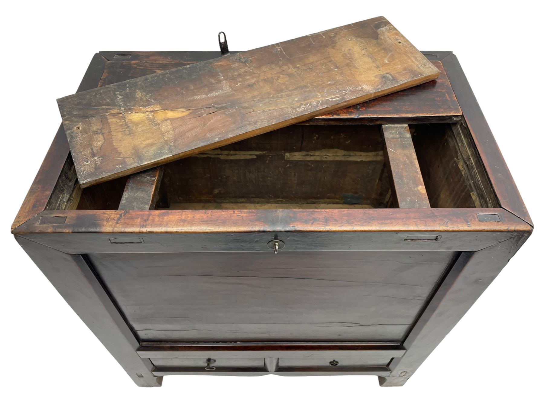 17th to 18th century Chinese fruitwood chest, possibly Gansu region, the lift-up lid with an iron strap set with two Chinese 'cash' coins, panelled front, sides and back, fitted with two small drawers, stile supports with shaped lower rail