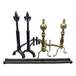 Pair of wrought iron fire dogs with fleur-de-lis finials upon twisted stems, together with pair of brass fire dogs etc, tallest H56cm
