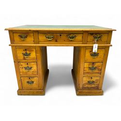 Rustic pine twin pedestal desk, rectangular green leather inset top above a central frieze drawer flanked by two short drawers, each pedestal featuring three graduated drawers, raised on a plinth base