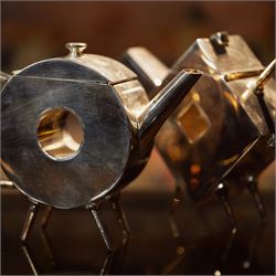 Manner of Christopher Dresser (1834-1904) - two art deco design silver plated teapots, of ...