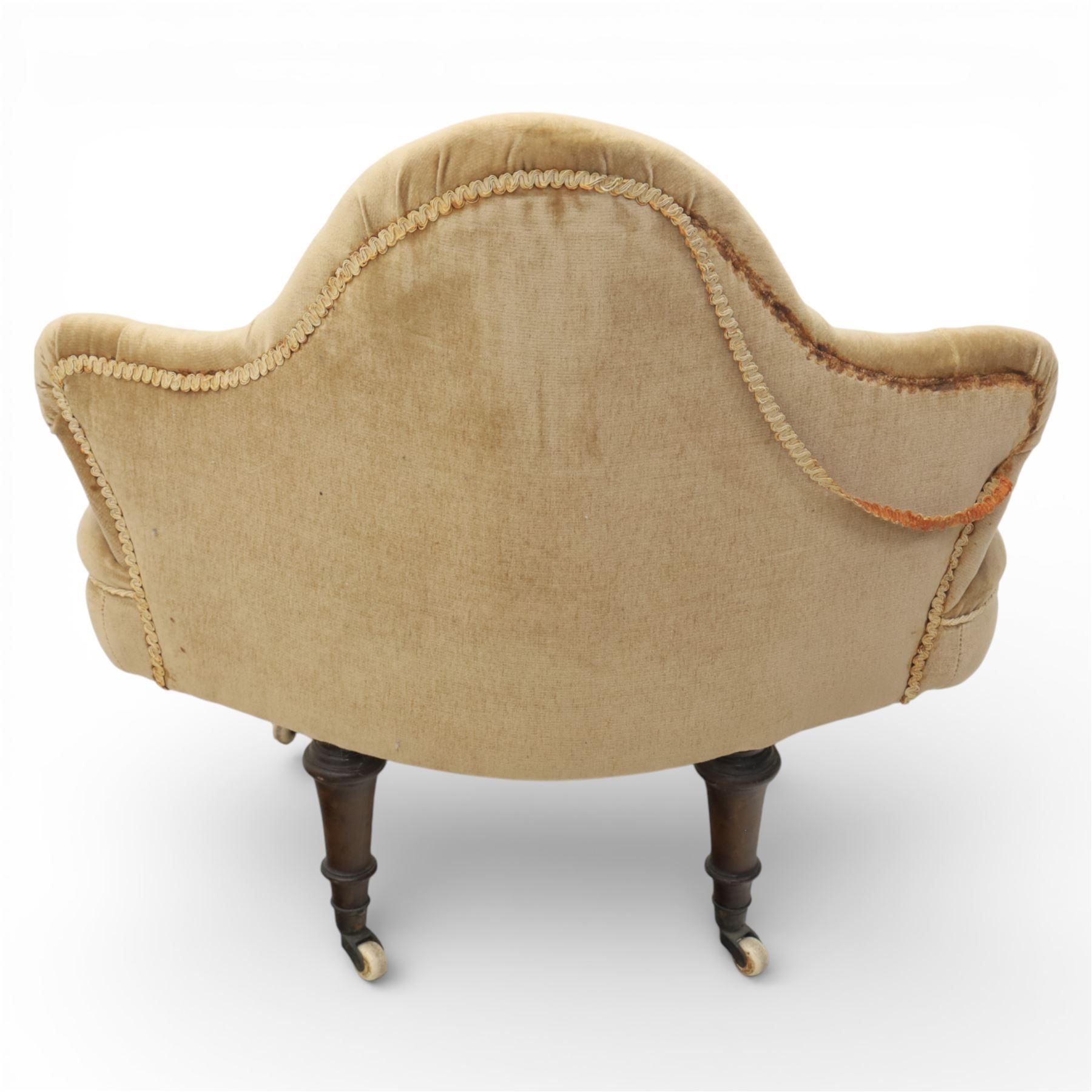 20th century pair of bedroom chairs upholstered in buttoned taupe velour, each of slipper chair form with low wraparound back and deep seat, the backs button tufted with padded wings, raised on turned front supports with castors