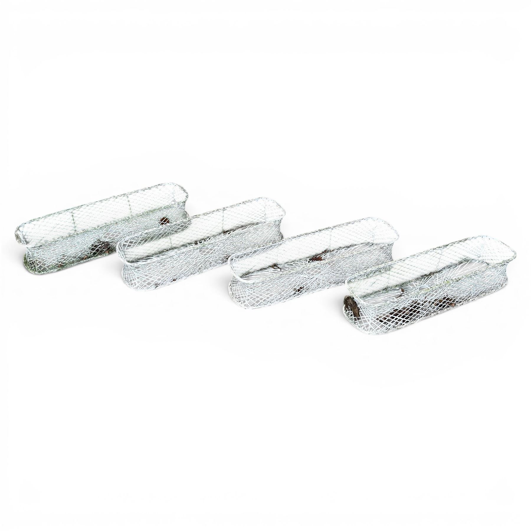 Four early 20th century French painted wicker garden planters, rectangular lattice form with shaped ends