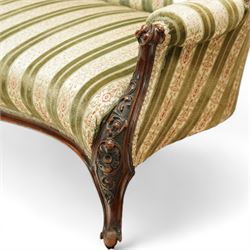 Victorian walnut framed salon sofa, the shaped back and scroll arms with carved floral detail, upholstered in green and cream striped fabric, raised on scrolled cabriole legs 