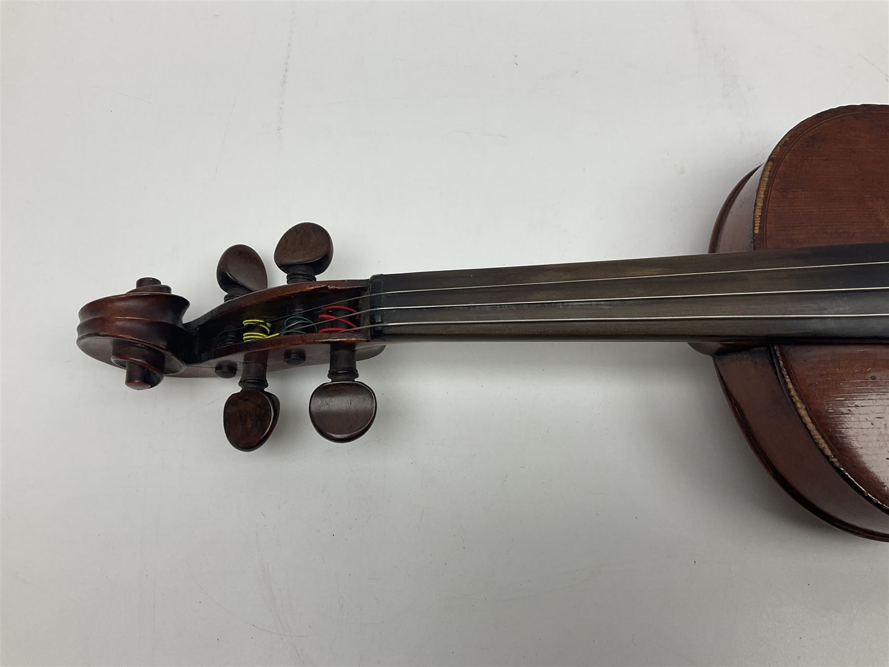 German violin c1890 with 36cm two-piece maple back and ribs and spruce top; bears label 'Antonius Stradivarius Cremona Faciebat Anno 1729' L59.5cm overall; in ebonised wooden 'coffin' case; and two German violins c1890 for completion - one bearing a Stradivarius label, the other a Ruggeri label; both in carrying cases (3)