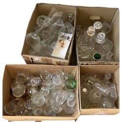 Glassware to include decanters, candlesticks, tumblers, coloured glassware etc in four boxes