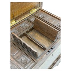 Zanzibar chest, early 20th century, of hardwood construction with brass inlaid foliate and geometric decoration to the lid, fitted interior of multiple carved compartments, with brass strapwork, side handles, and shaped bracket feet