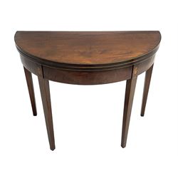 George III mahogany demi-lune tea table, fold-over top with band and stringing, the frieze inlaid with fan motifs, double gateleg action base, on square tapering supports