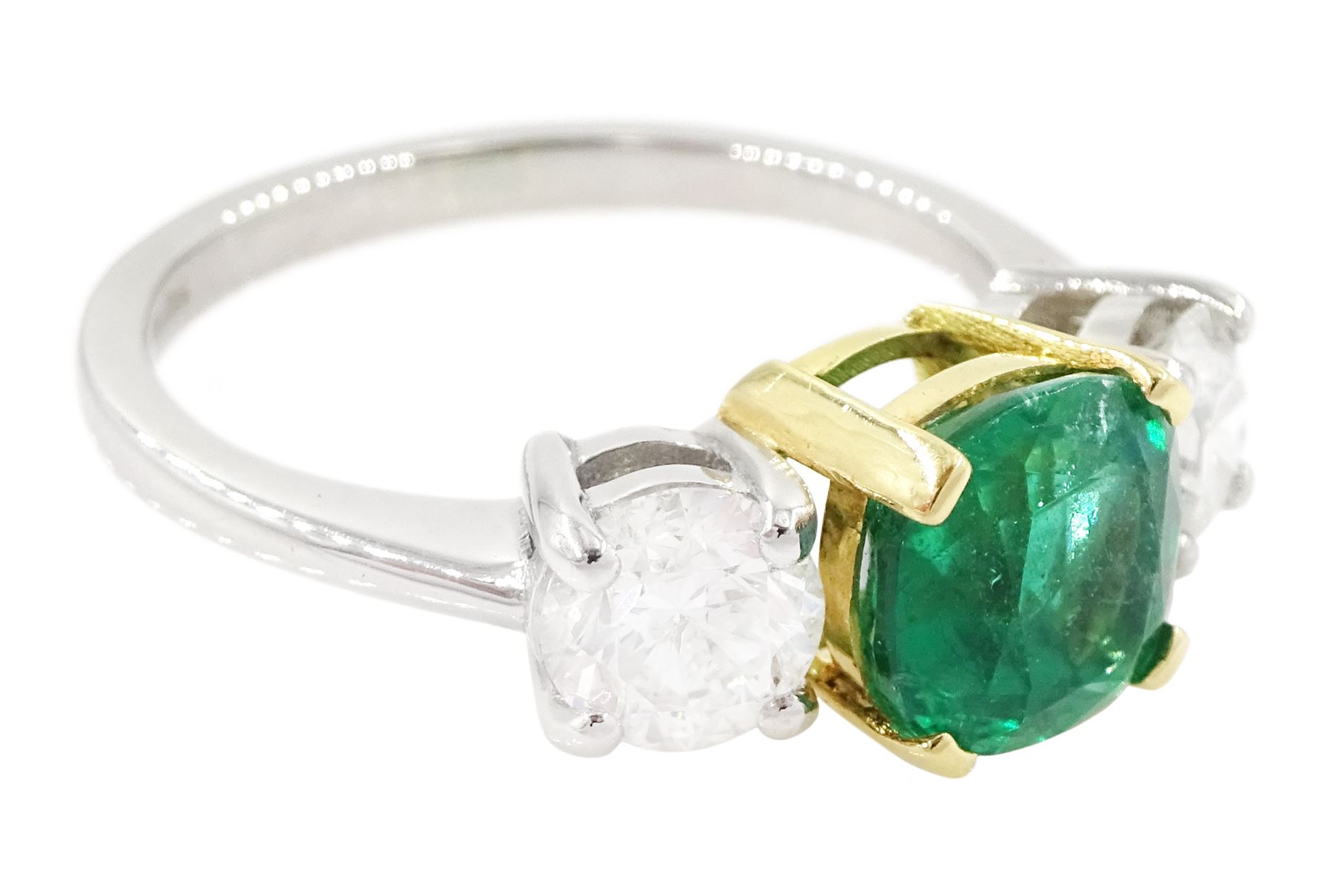 Platinum emerald and diamond three stone ring, single cushion cut emerald of approx  1.85 carat, set with a single round brilliant cut diamond either side, hallmarked, total diamond weight approx 1.20 carat