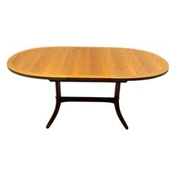 G-Plan - mid-20th century teak extending dining table, oval top with concealed central butterfly leaf extension, raised on splayed supports with cross-stretcher; three dining chairs with curved top rail and vertical splats