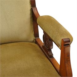 Pair of late Victorian mahogany carved open armchairs, with carved cresting rail, above upholstered seat, back and arms, raised on turned supports terminating in castors