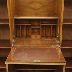 Art Deco walnut bureau bookcase, top with moulded and rounded edges and stepped front profile, central shelf, and fall-front bureau section with vertical and horizontal pigeon holes and a small drawer, above two cupboard doors and flanked by two tall glazed display cabinets with single doors and geometric sunburst design astragal glazing bars enclosing three shelves, raised on cavetto shaped plinth base 