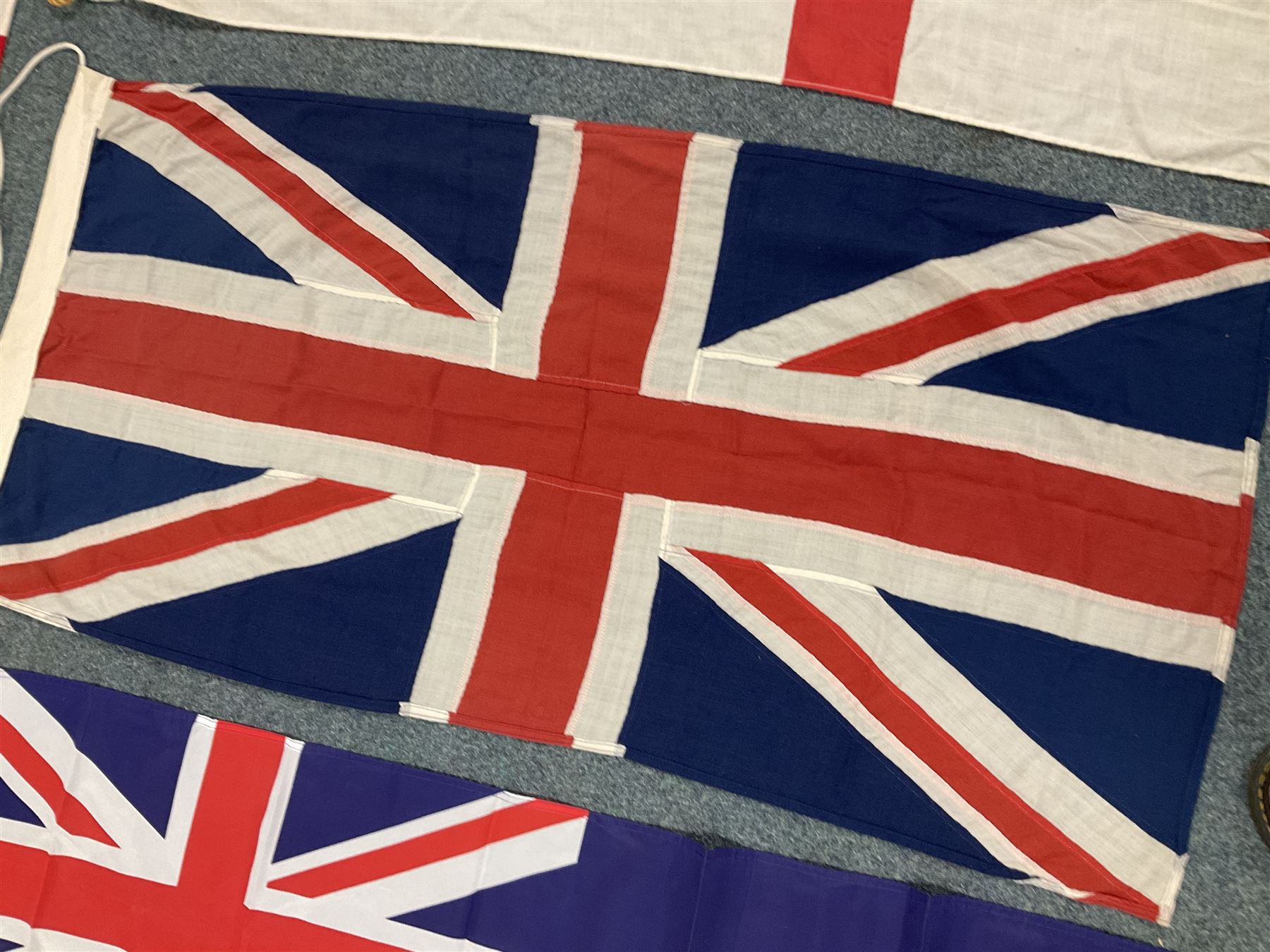 Six flags - White Ensign 180 x 86cm; two Union flags 180 x 86cm and 132 x 62cm; Falklands Islands 153 x 89cm; Yorkshire Rose 153 x 89cm; and QEII 1953 Coronation 84 x 57cm (6)