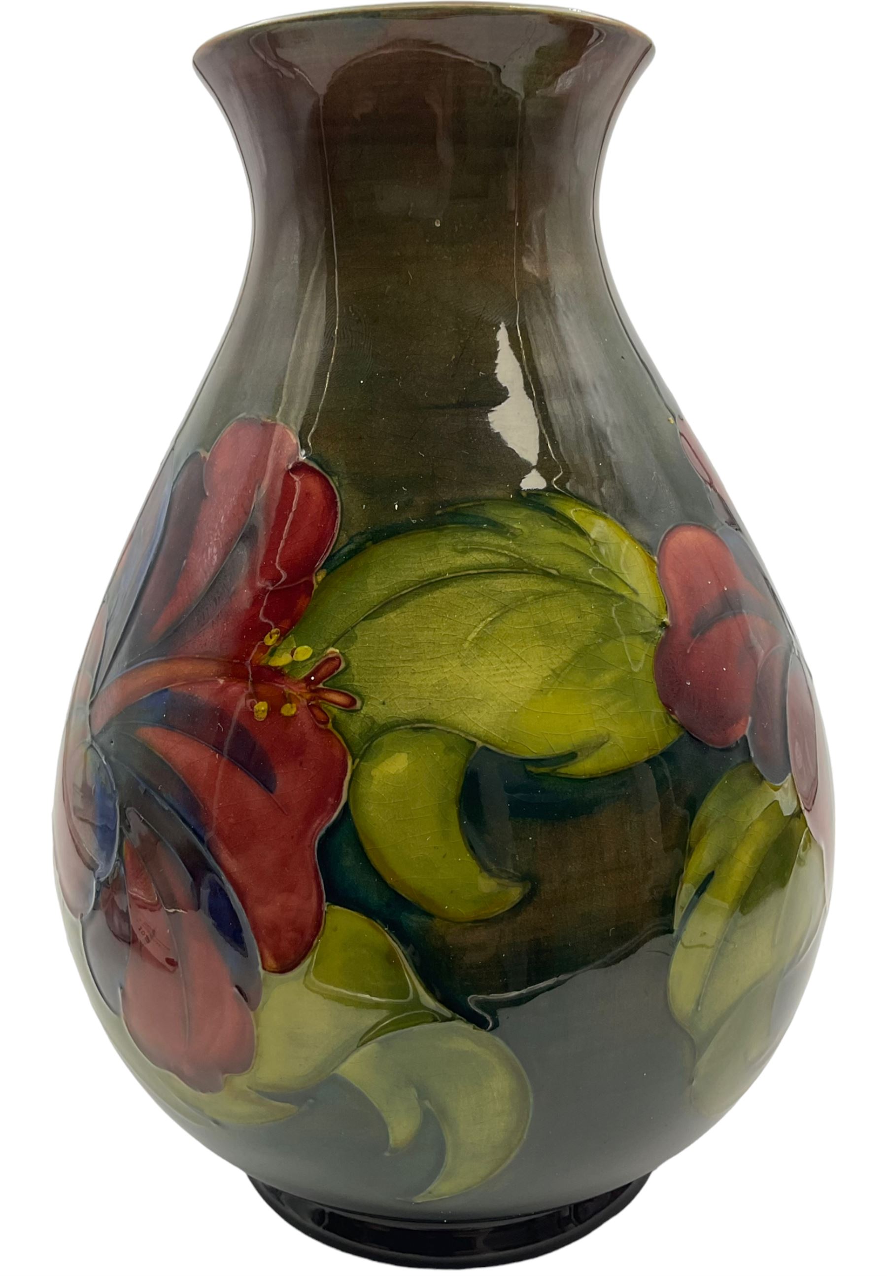 Moorcroft vase of bulaster form, decorated in Hibiscus pattern upon a green ground, H21cm 