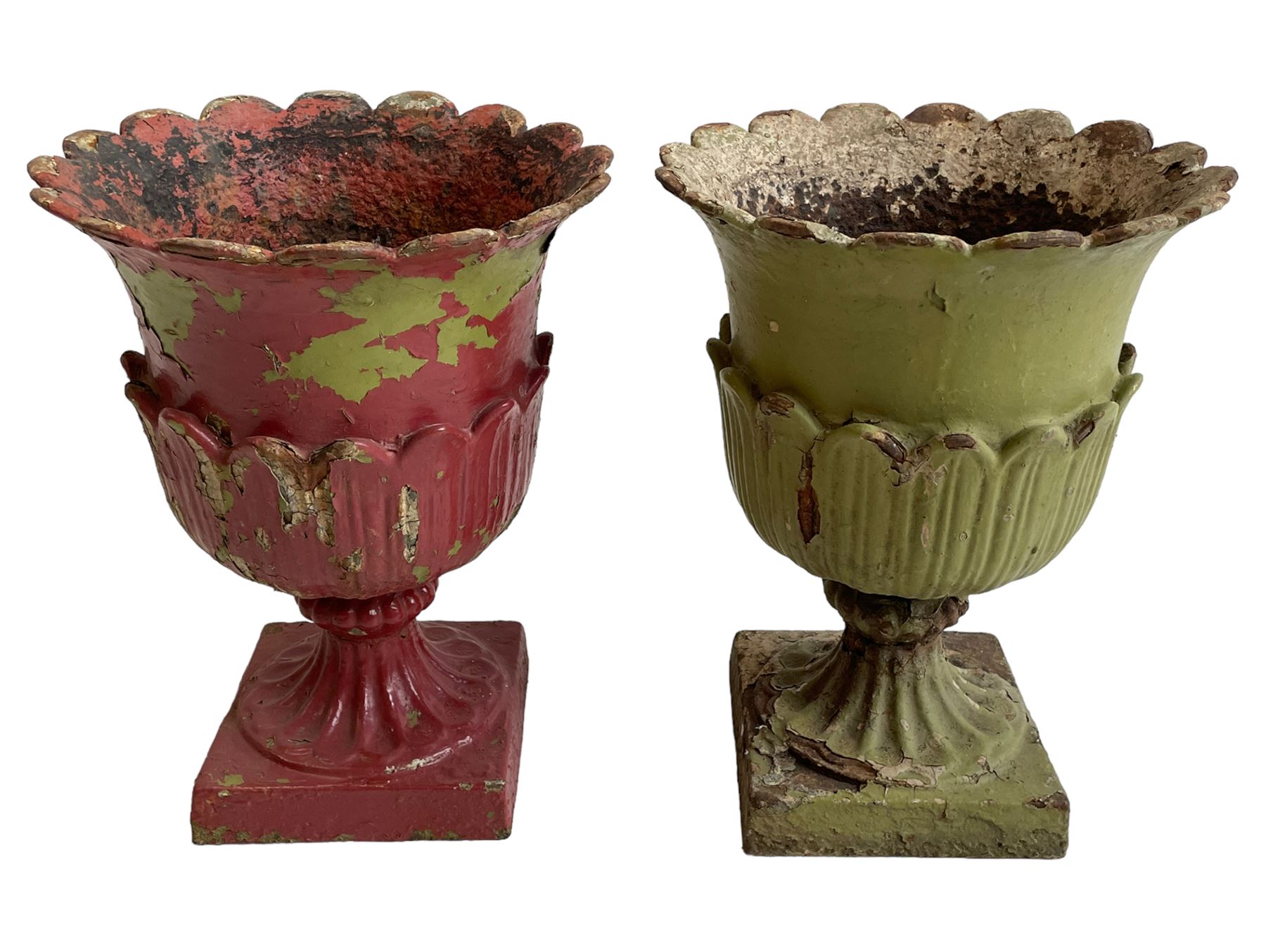 Pair of Victorian cast iron lotus garden urns, the shaped rim over lappet cast underbelly, on moulded footed base